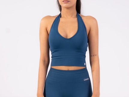 Woman wearing a blue athletic outfit on a white background