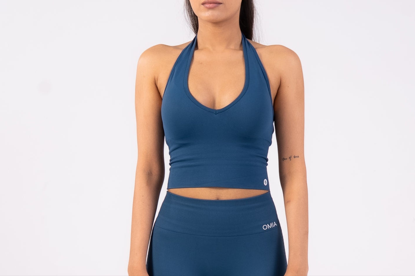 Woman wearing a blue athletic outfit on a white background
