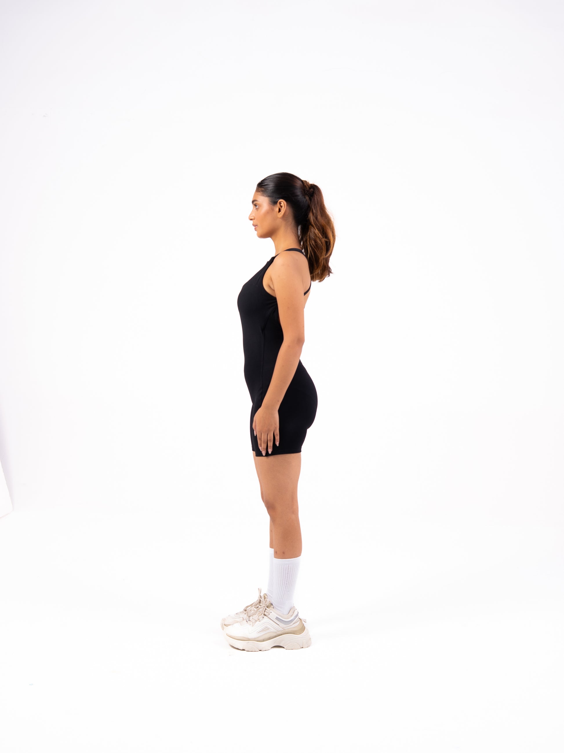 Woman wearing a black sleeveless dress on a white background